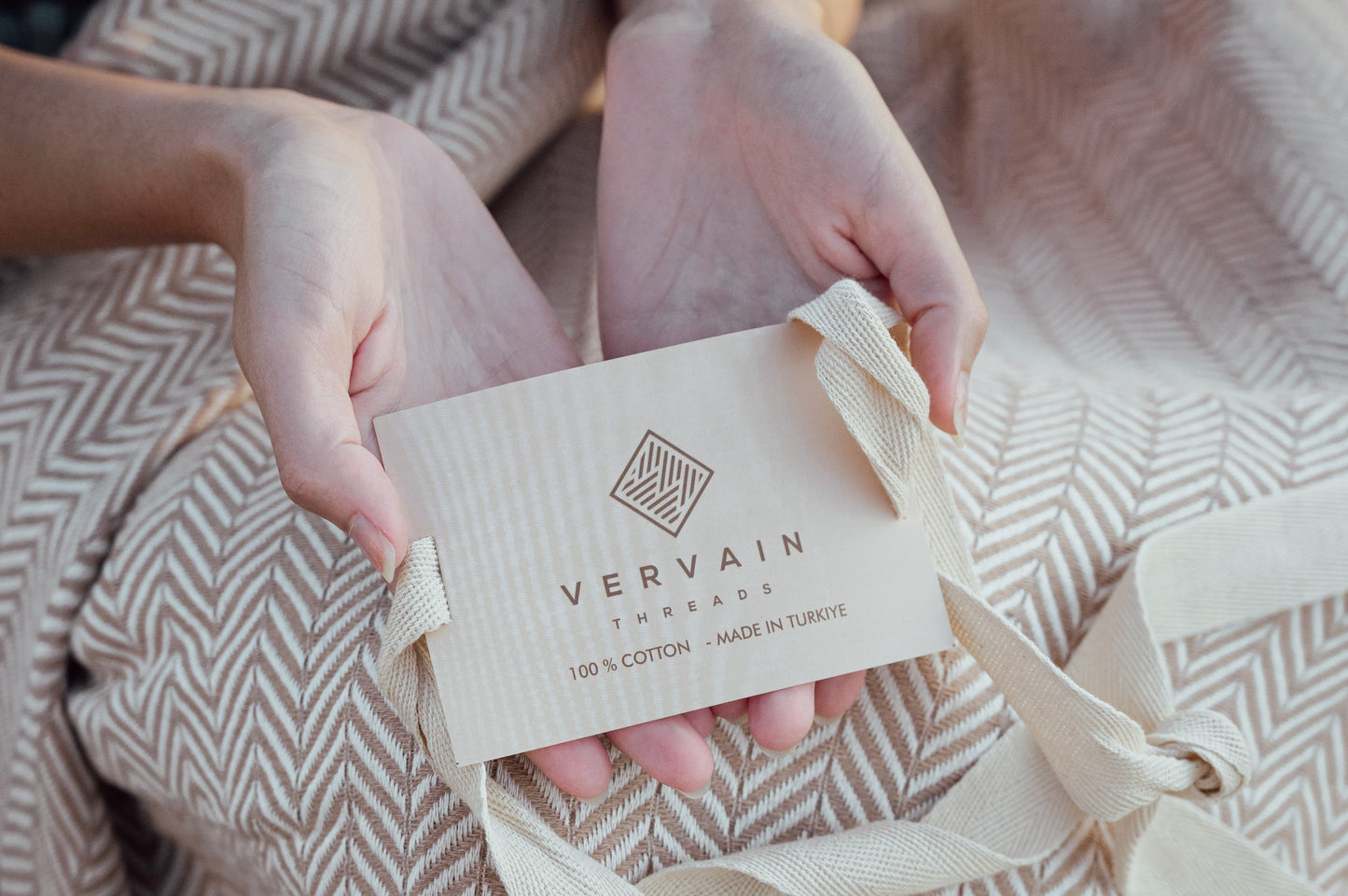 An image of a person holding the Vervain Threads packaging label.